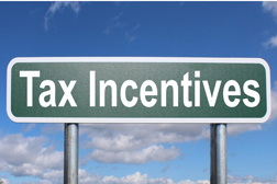 A green road sign  with the words: Tax incentives.