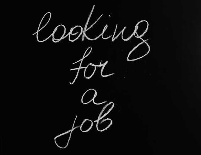 A blackboard with the words: Looking for a job, written in white chalk.