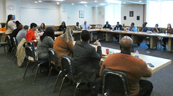 20 people gathered in a conference room for a meeting.
