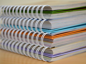 Stack of spiral-bound documents.