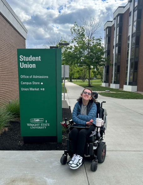 Lily in her electric wheelchair outside the Wright State University Student Union.