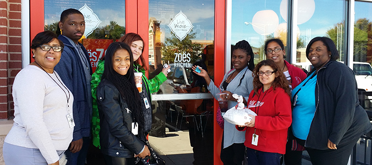 Six WTC WRP participants and two travel training instructors at Zoe's Kitchen, a WRP training site.